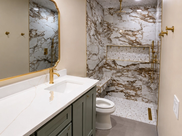 Finished Bethany bathroom remodel with a quartz-topped vanity, brushed gold fixtures, and a marble-look tile walk-in shower by MASB Construction & Remodeling LLC