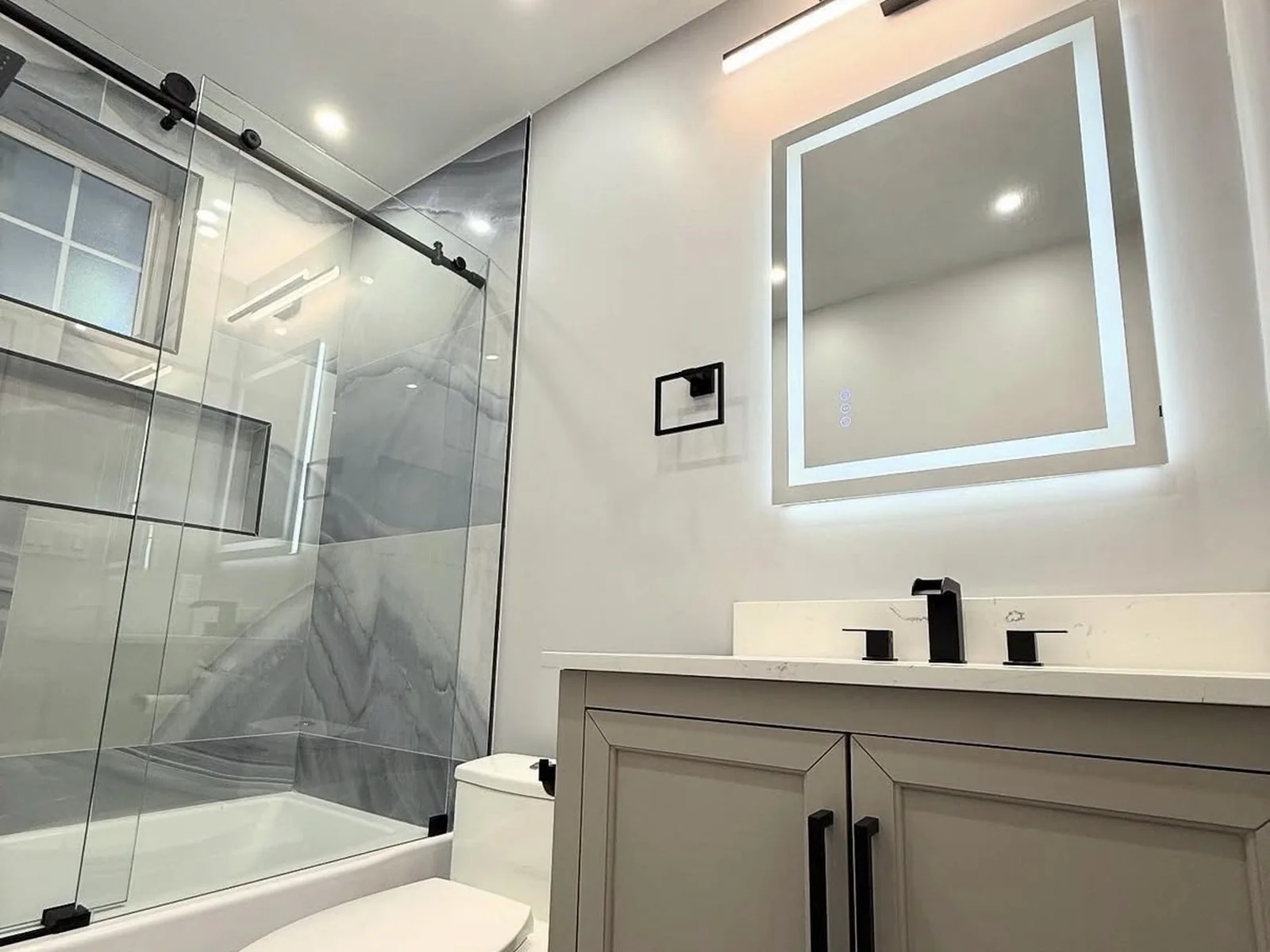 Finished modern bathroom renovation in Edmond with new vanity, tile, and fixtures by MASB Construction