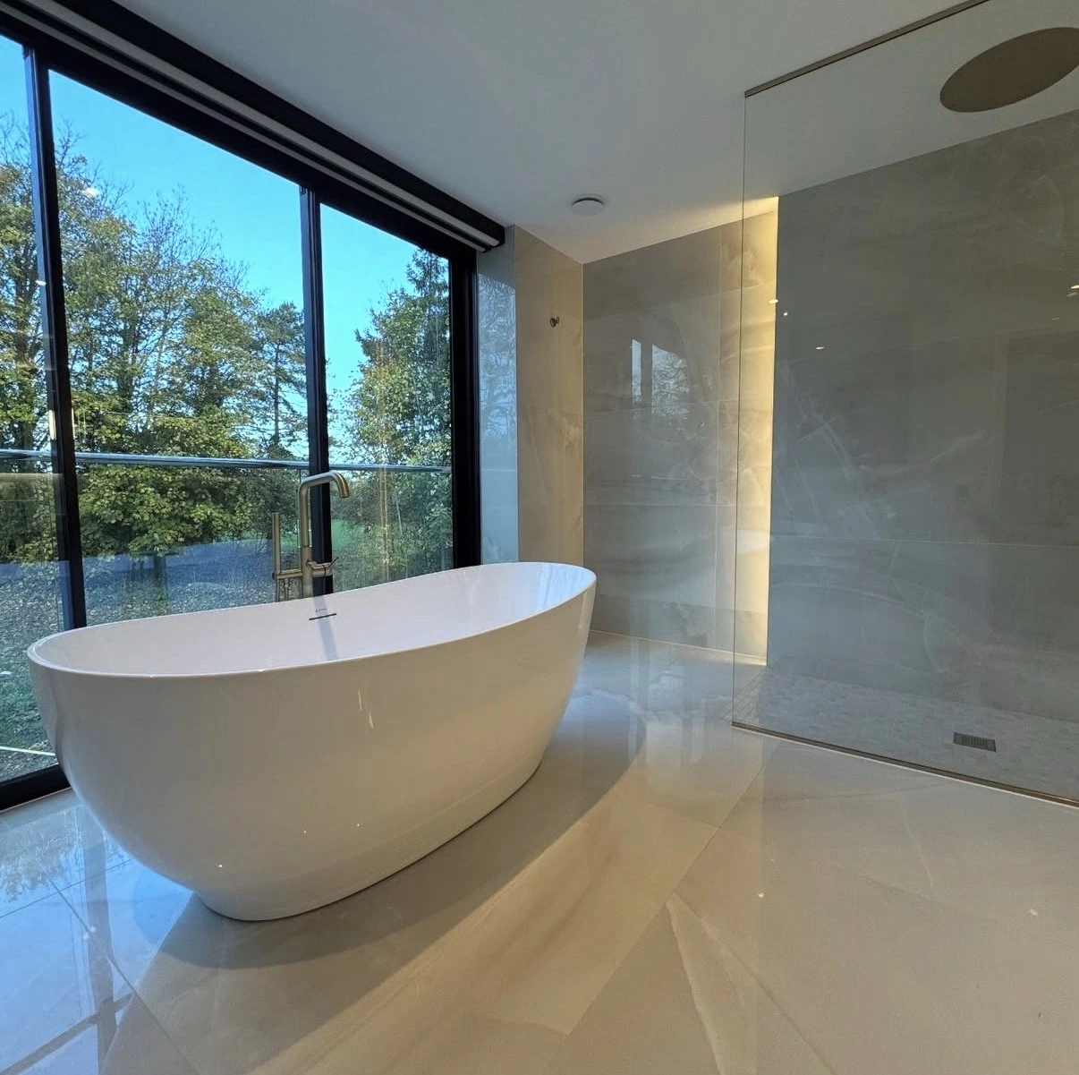 Finished spa-style bathroom remodel in Norman with walk-in shower by MASB Construction