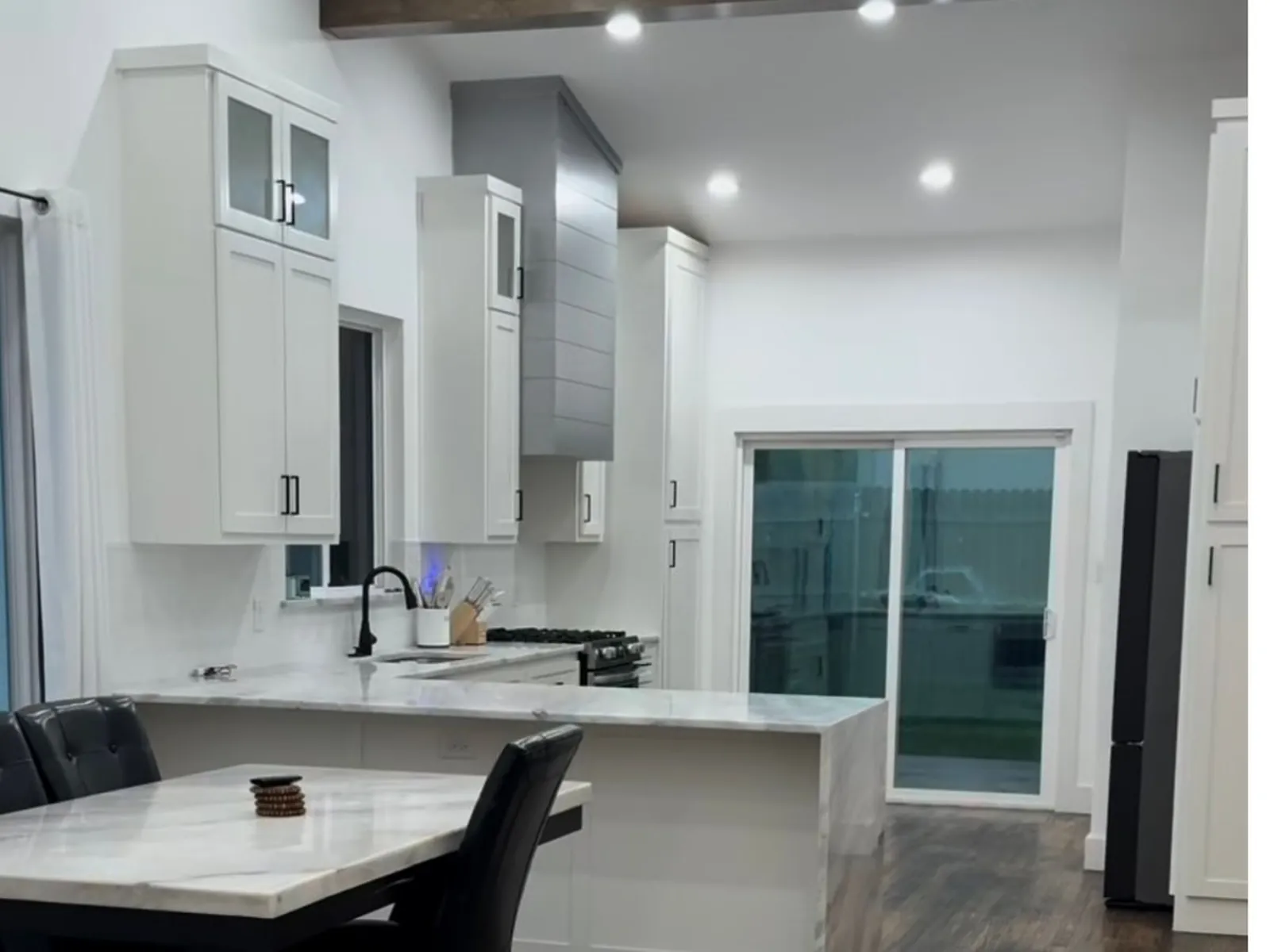 Kitchen island and open sight lines after wall removal in a Norman, Oklahoma kitchen remodel by MASB Construction