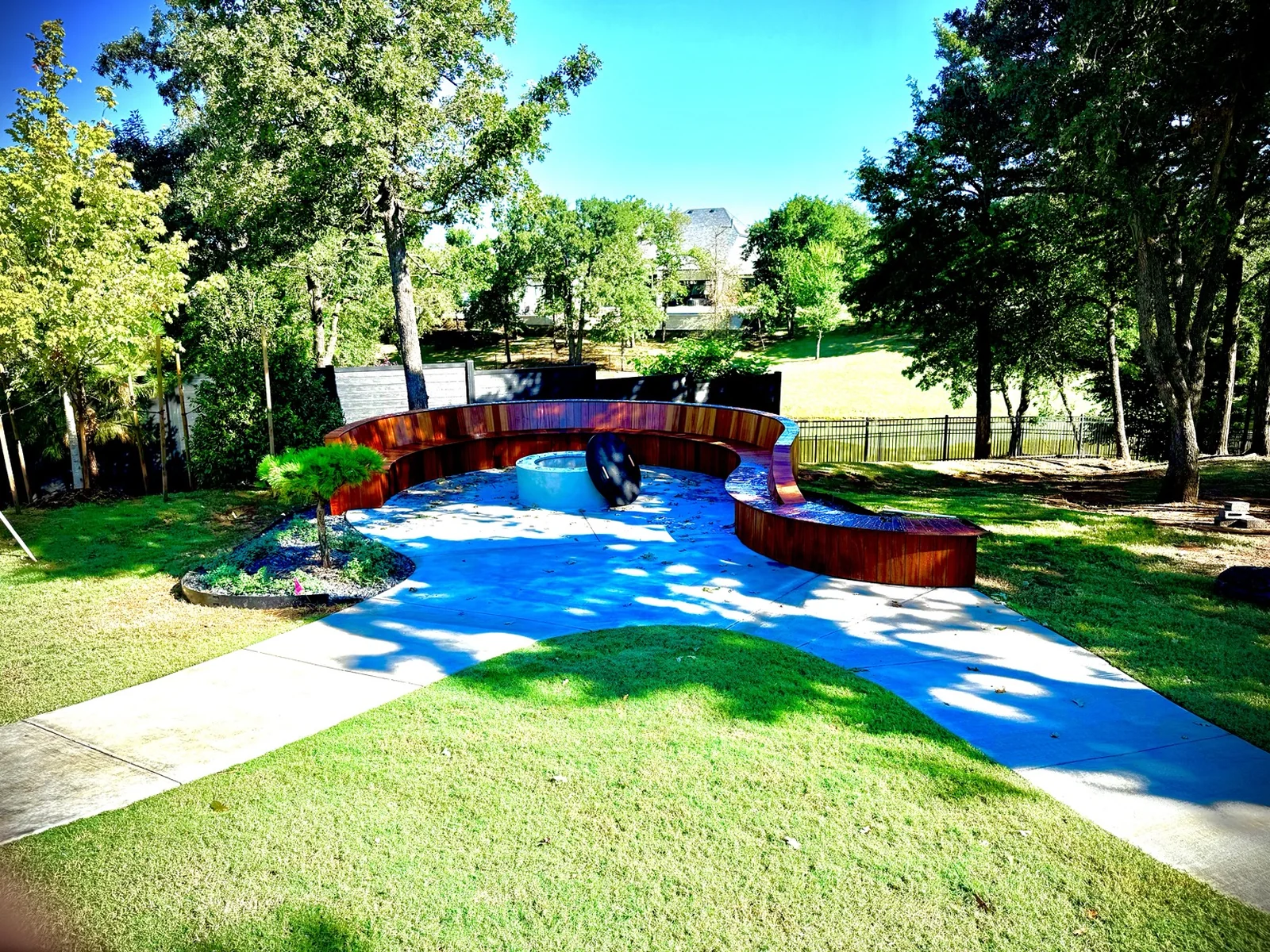 Custom fire pit and curved seating remodel in Edmond by MASB Construction