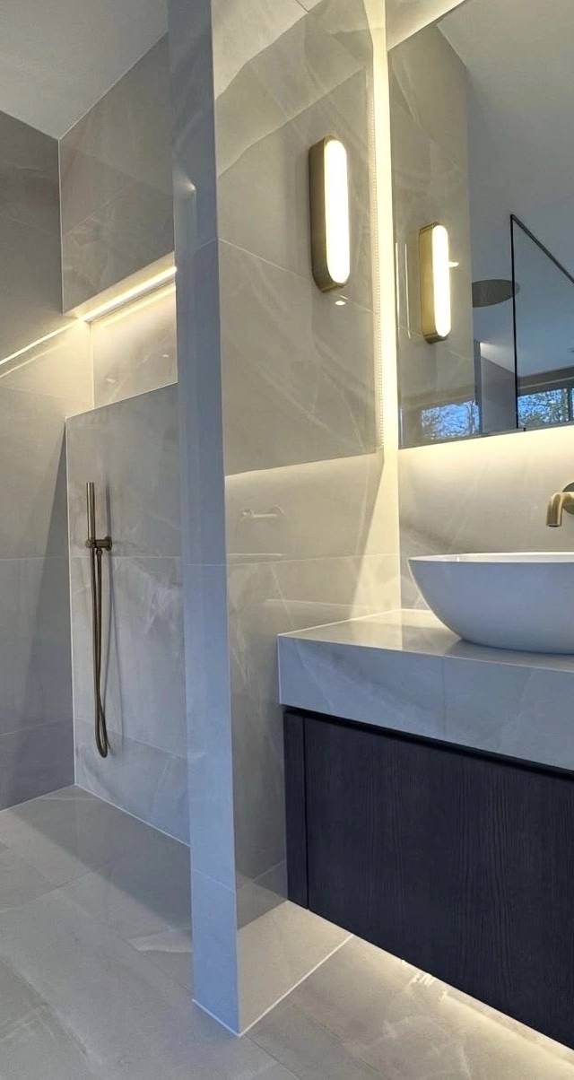 Modern bathroom fixtures in Norman remodel by MASB Construction