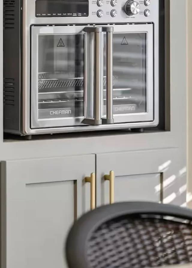 Appliance niche built into gray shaker cabinetry with gold pulls in a Piedmont kitchen remodel